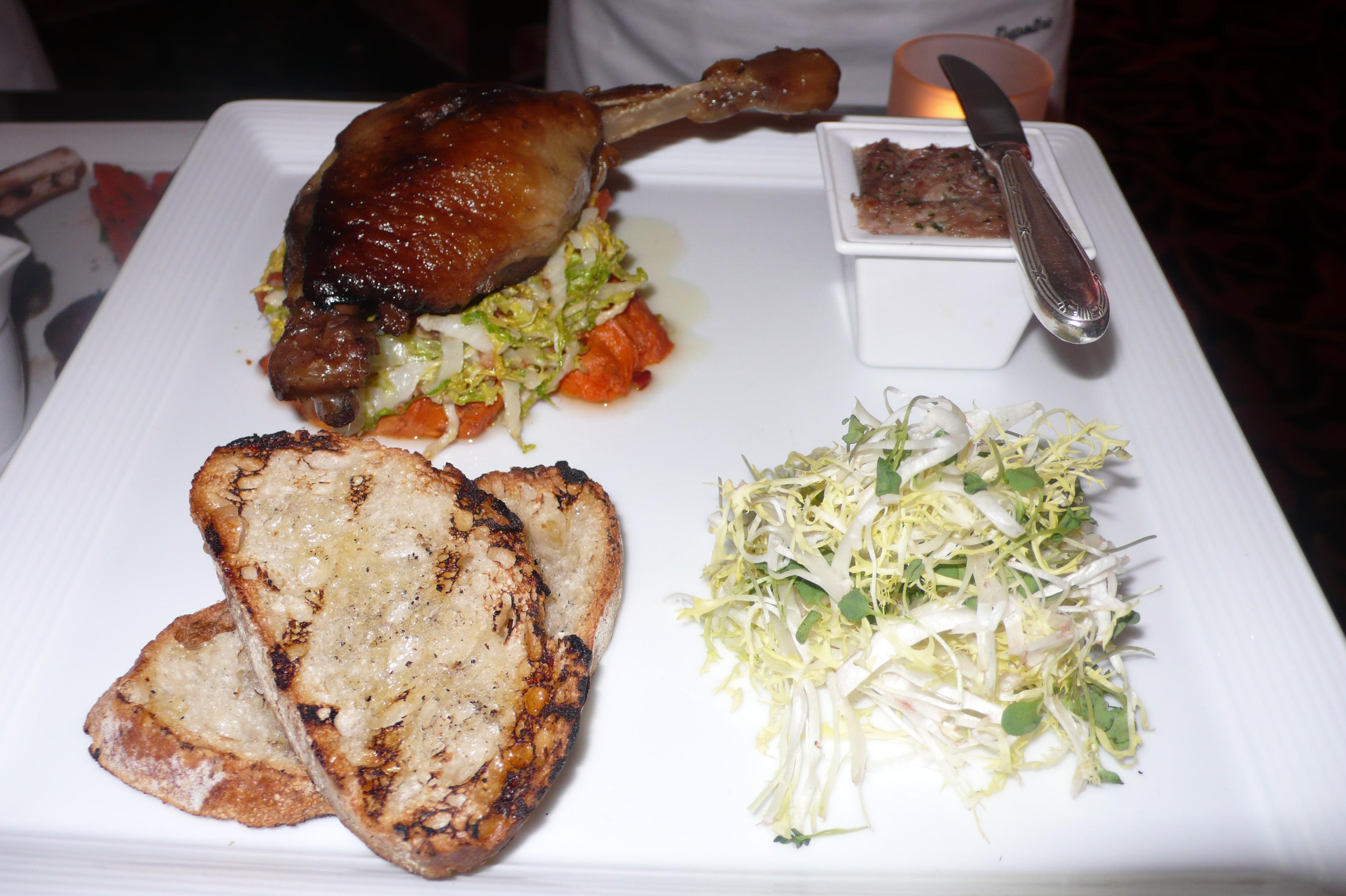Roasted duck confit with sweet yams, sauteed cabbage and duck rillette