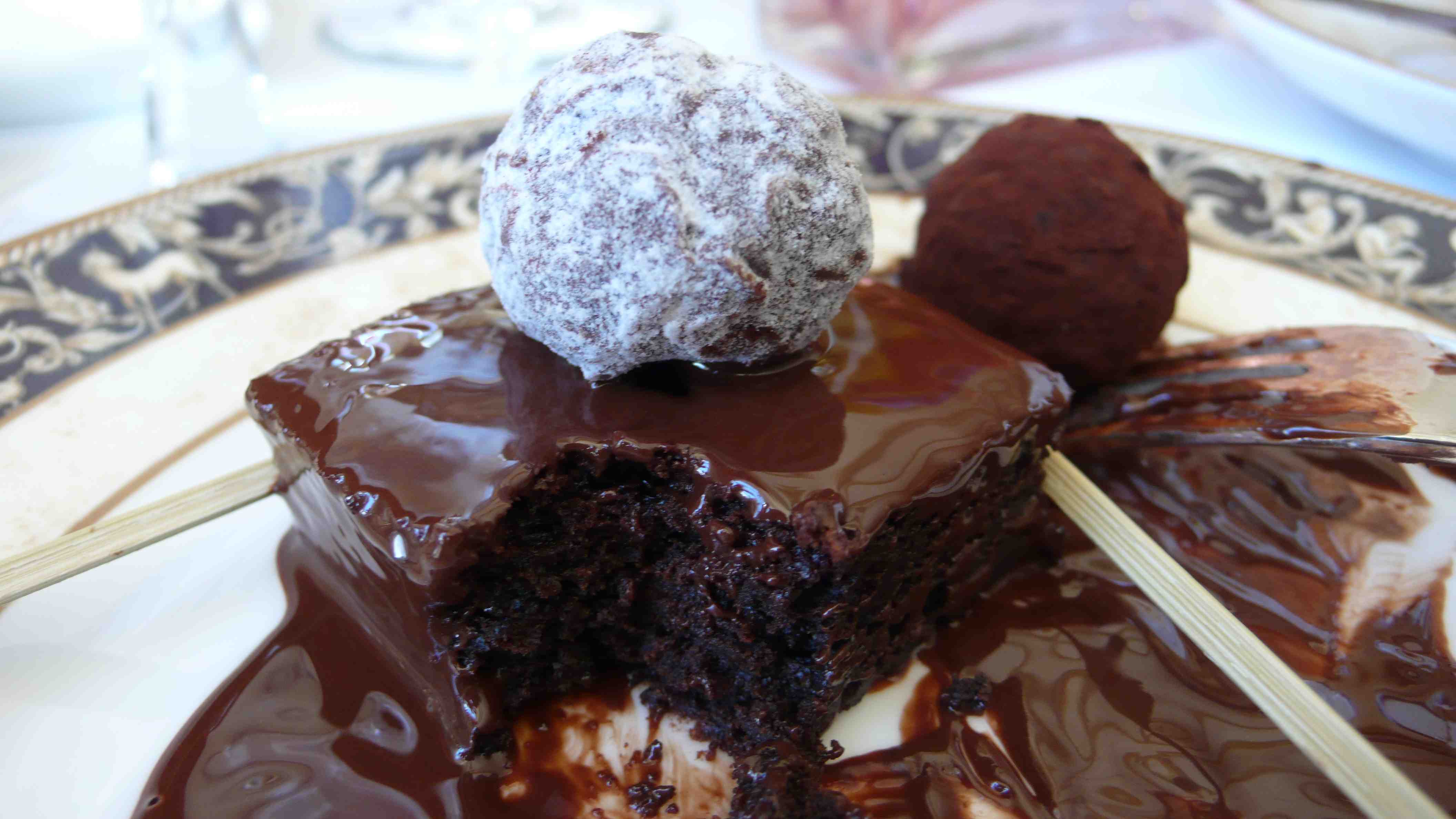 Brownie drenched in chocolate, with a truffle