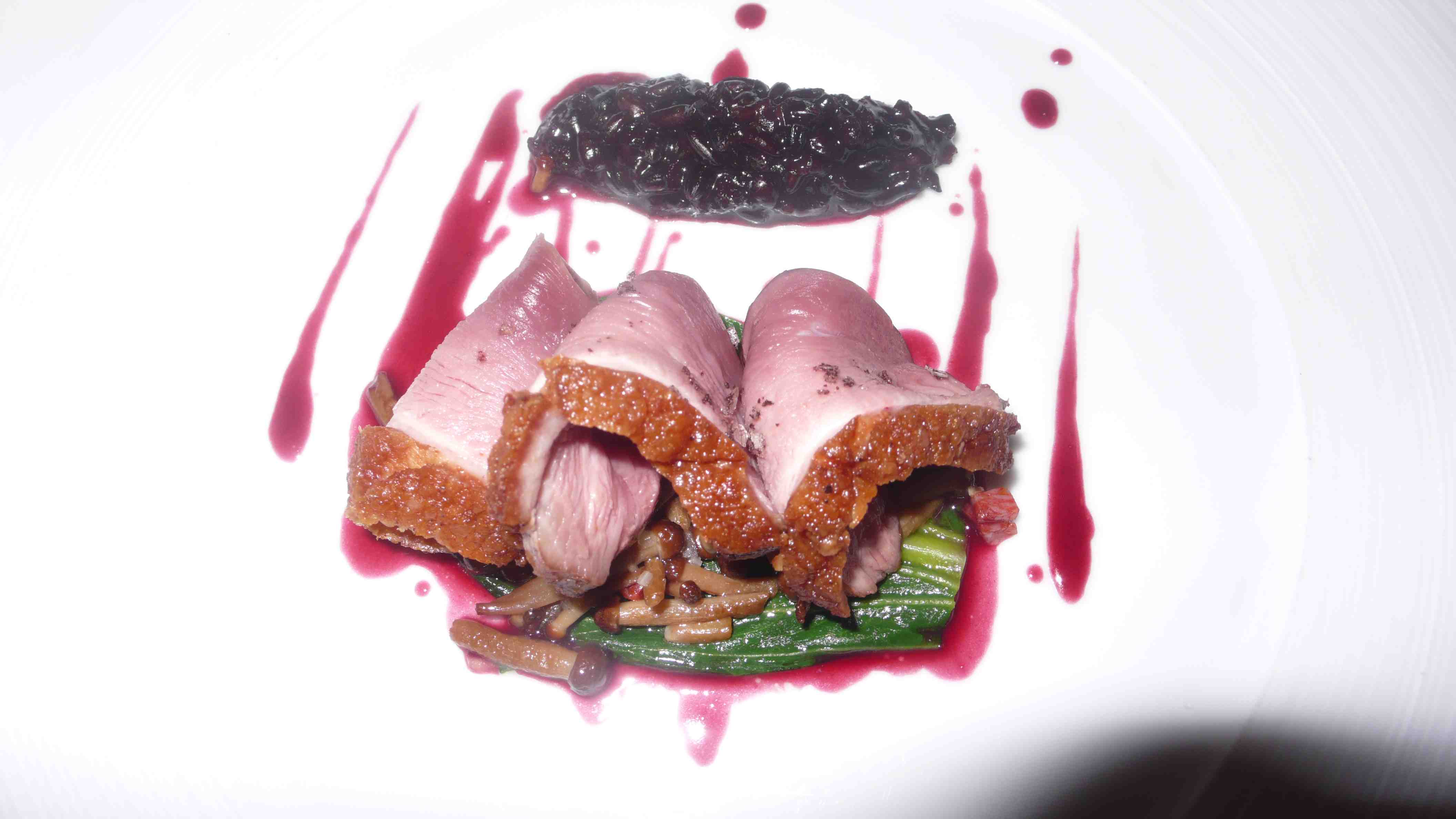 Duck with black rice and enoki mushrooms